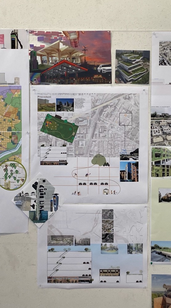 A studio wall of urban design boards, maps and axonometric drawings