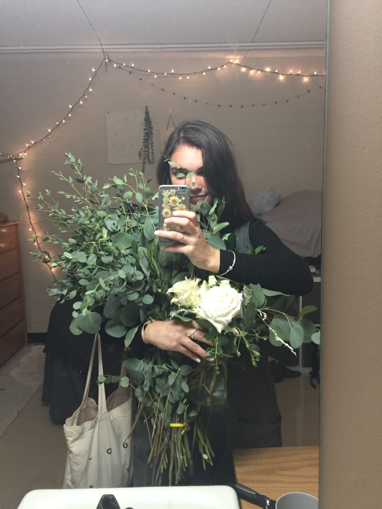 Eucalyptus and orange lilies filling a kitchen sink