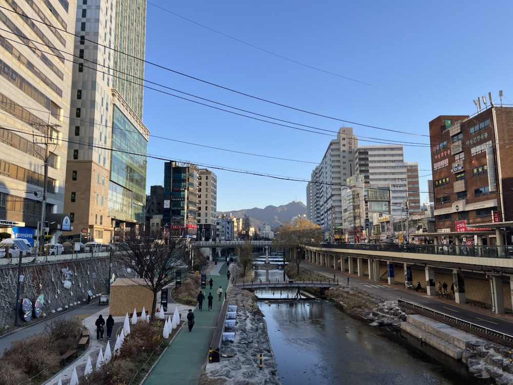 Cheonggyecheon stream with mountains beyond, Seoul