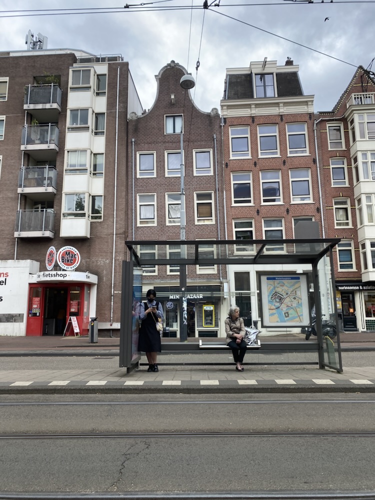 Tram stop in front of gabled canal houses, Amsterdam