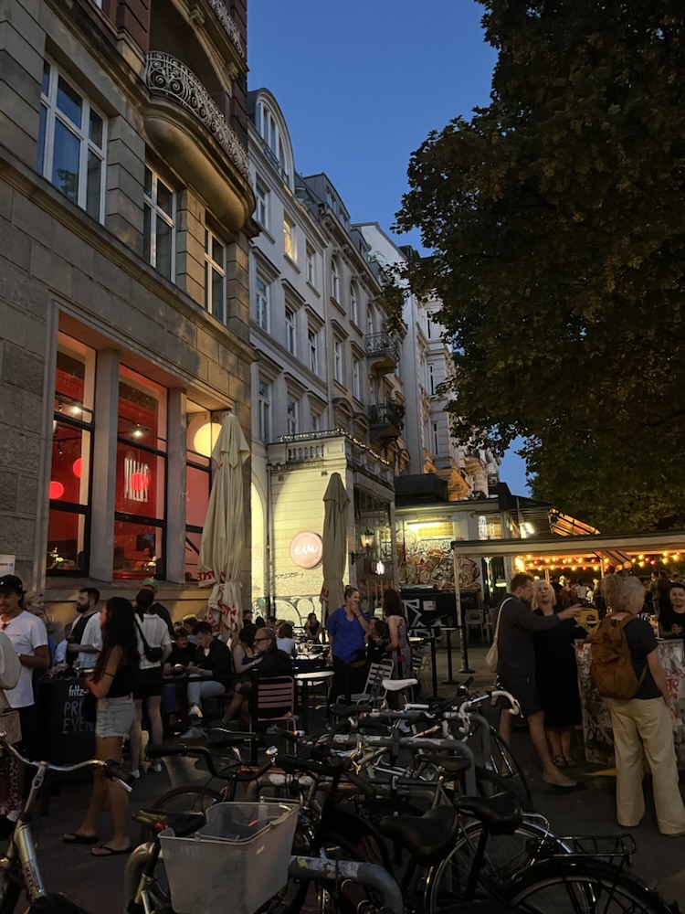 Summer evening outside a café in Hamburg, bicycles parked along the curb