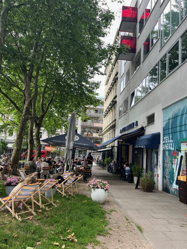 Deck chairs and umbrellas set out along a Hamburg street