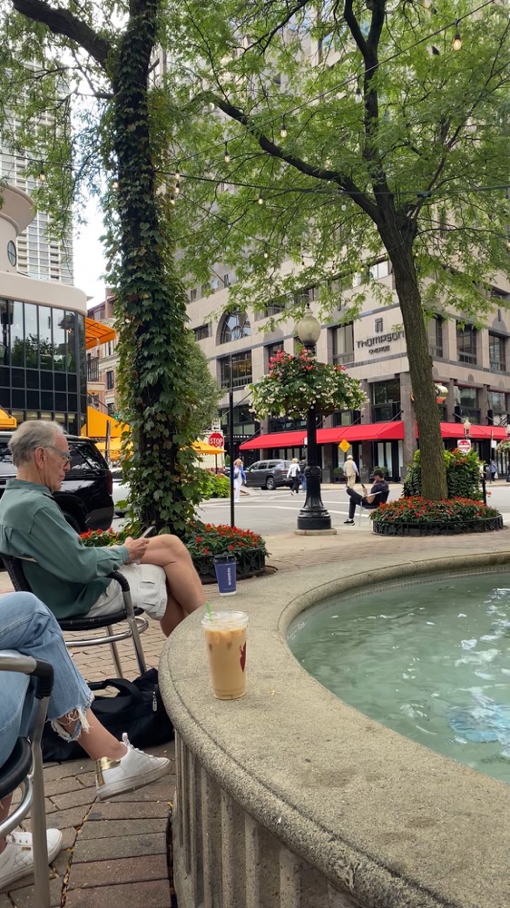 A man sitting beside the fountain in Mariano Louis Park, Chicago